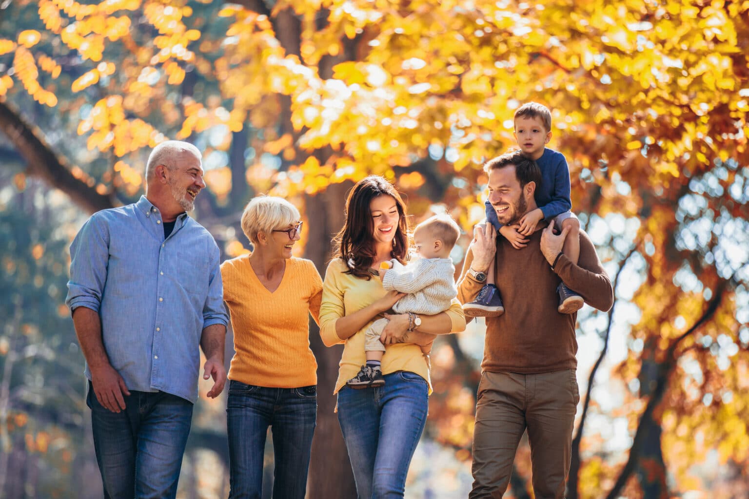 Multl generation family in autumn park having fun